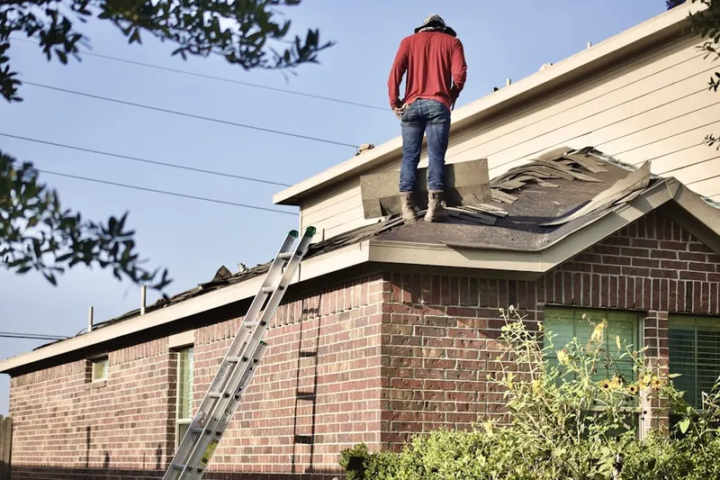 Professional roofer working on a residential roof in Forest City